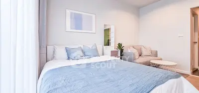 Chic and cozy bedroom with stylish decor and natural light, perfect for relaxation and comfort.