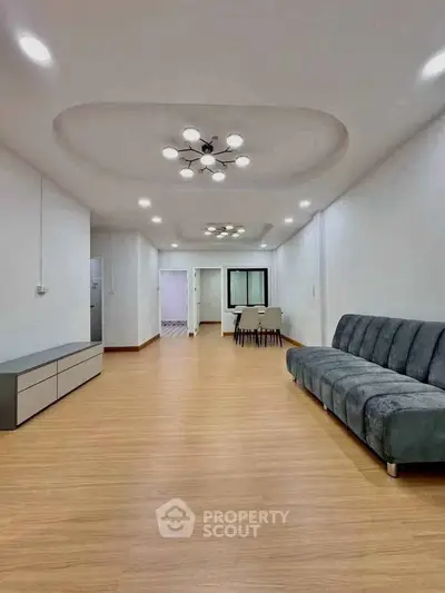 Spacious modern living room with elegant lighting and sleek furniture