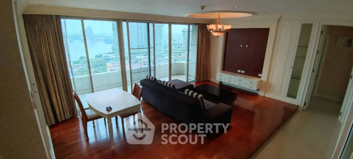 Spacious living room with panoramic city view and elegant wooden flooring.