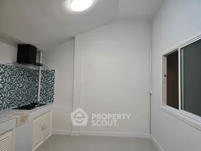 Modern kitchen with sleek design and gas stove, featuring stylish mosaic backsplash.