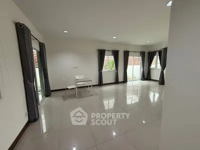 Spacious empty room with large windows and tiled floor, ideal for customization.