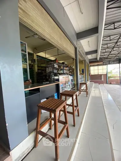 Charming commercial space with open seating and modern design, ideal for a cafe or retail business.