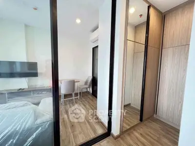 Modern apartment interior with mirrored wardrobe and cozy living area