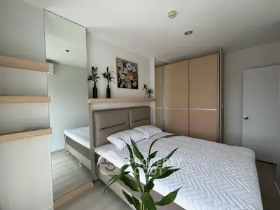 Modern bedroom with stylish decor and ample storage in a contemporary apartment.
