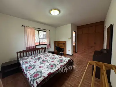 Spacious bedroom with wooden furniture and natural light