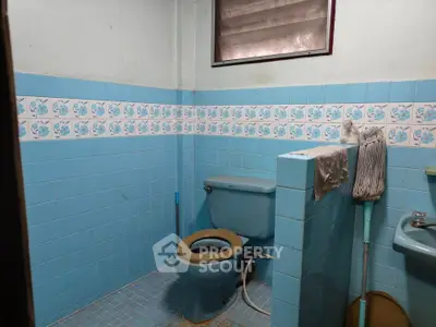 Charming vintage bathroom with blue tiles and classic fixtures, perfect for a retro renovation project.