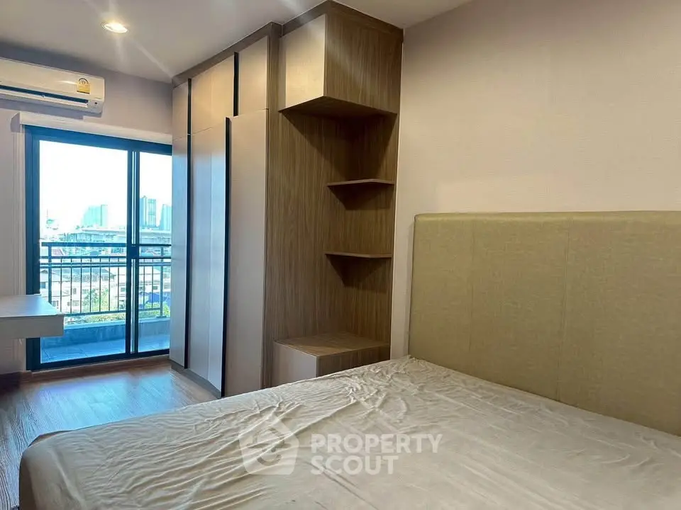 Modern bedroom with balcony view and stylish wooden wardrobe in urban apartment