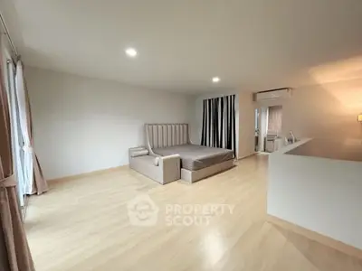 Spacious modern bedroom with elegant design and ample natural light