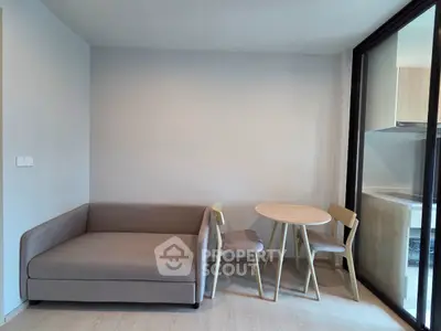Modern living room with cozy sofa and dining set in a bright apartment