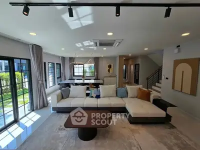 Spacious modern living room with large windows and stylish decor