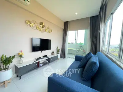 Modern living room with stylish decor and large windows offering natural light and scenic views.