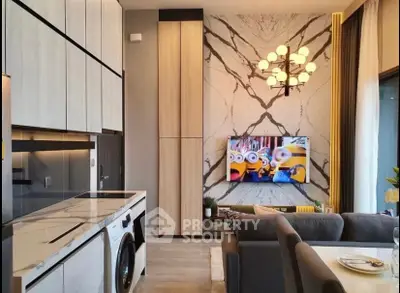 Modern living room with stylish decor, marble accents, and integrated kitchen appliances.