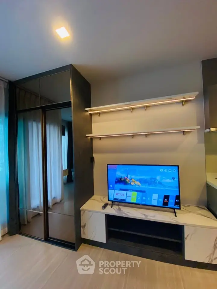 Modern living room with sleek TV unit and elegant shelving