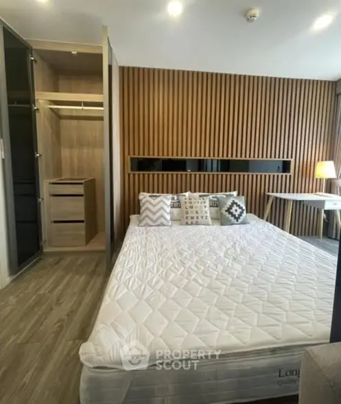 Modern bedroom with stylish wooden paneling and cozy lighting