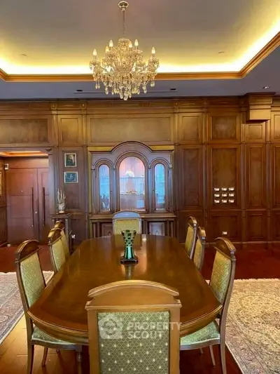 Luxurious dining room with elegant chandelier and classic wooden decor