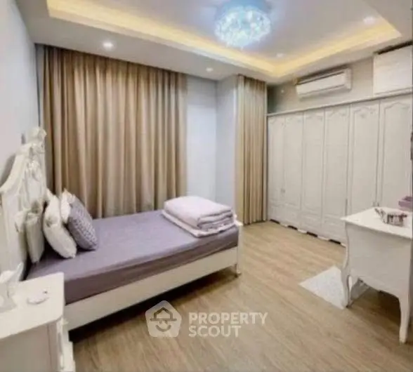 Elegant bedroom with modern lighting and ample storage in a stylish real estate property.