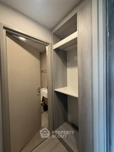 Modern apartment with sleek built-in storage and bathroom view
