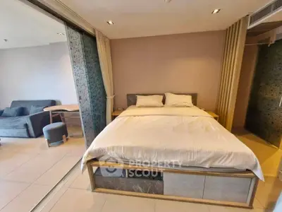 Modern bedroom with sliding glass doors and cozy seating area