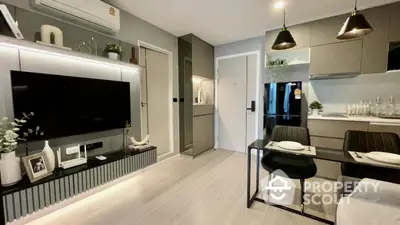 Modern living room with sleek kitchen, stylish decor, and dining area in open layout apartment.