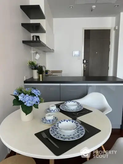 Modern kitchen with elegant dining setup and open shelves