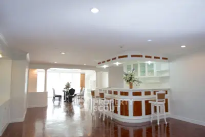 Spacious open-plan living area with elegant bar and dining space, perfect for entertaining.