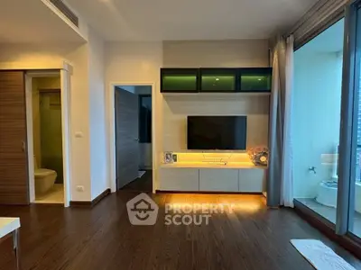 Modern living room with sleek TV setup and balcony view