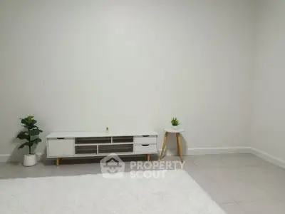 Minimalist living room with white furniture and decor plants