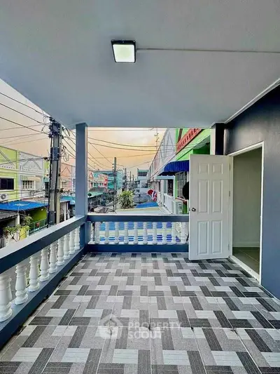 Spacious balcony with modern tile flooring and open view in urban setting