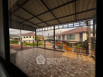 Spacious balcony with tiled flooring and scenic neighborhood view