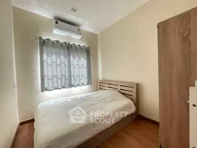 Cozy bedroom with natural light and modern furnishings, perfect for relaxation.