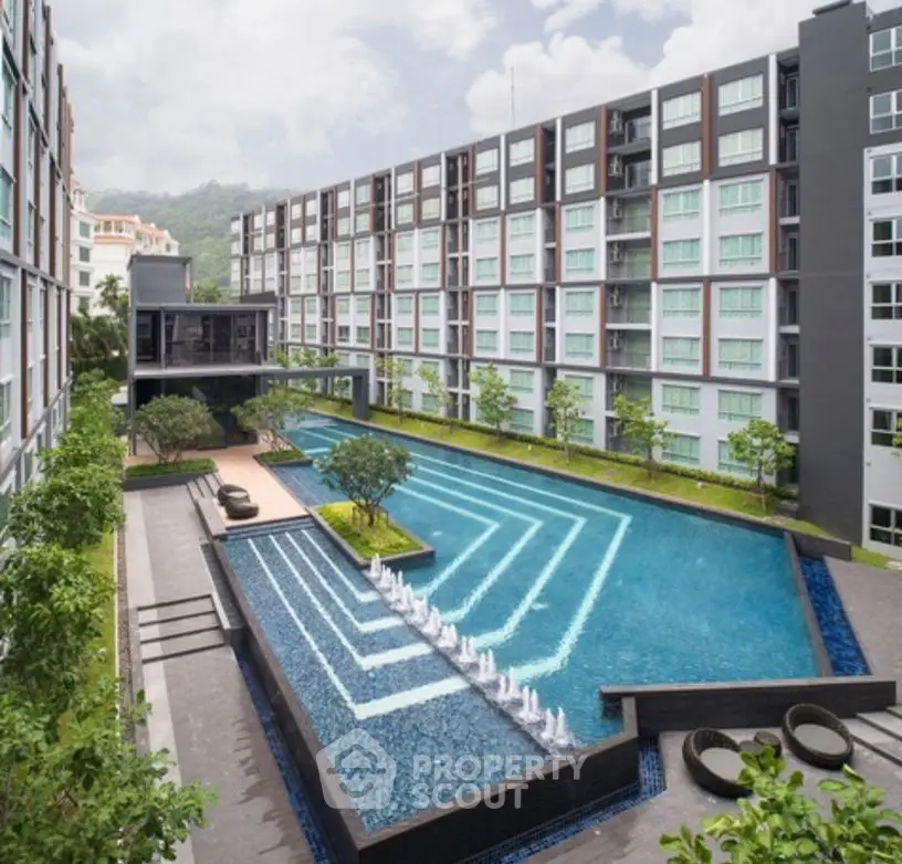 Modern apartment complex with stunning pool and lush greenery, offering luxury living and relaxation.