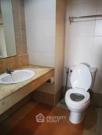 Modern bathroom with sleek fixtures and neutral tiles, perfect for a contemporary home.