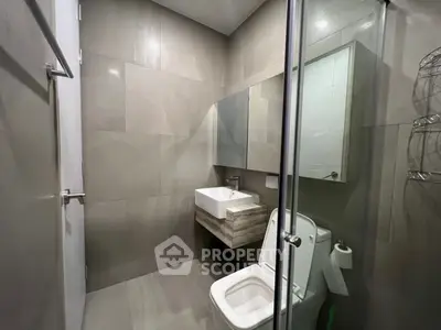 Modern bathroom with sleek design and contemporary fixtures in a stylish real estate property.