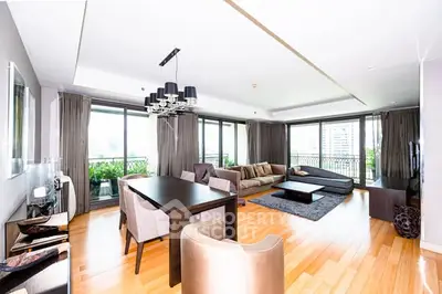 Spacious modern living room with elegant decor and large windows offering city views.