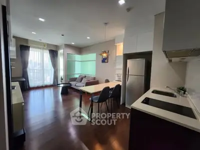 Modern open-layout kitchen and living room with sleek design and natural light.