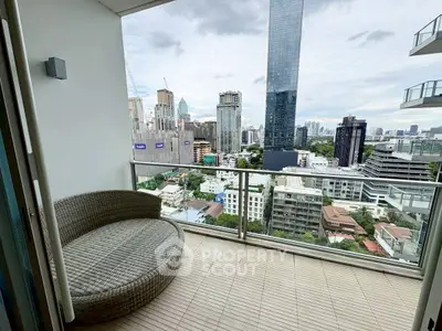 Luxurious balcony with stunning city skyline view and cozy seating area.