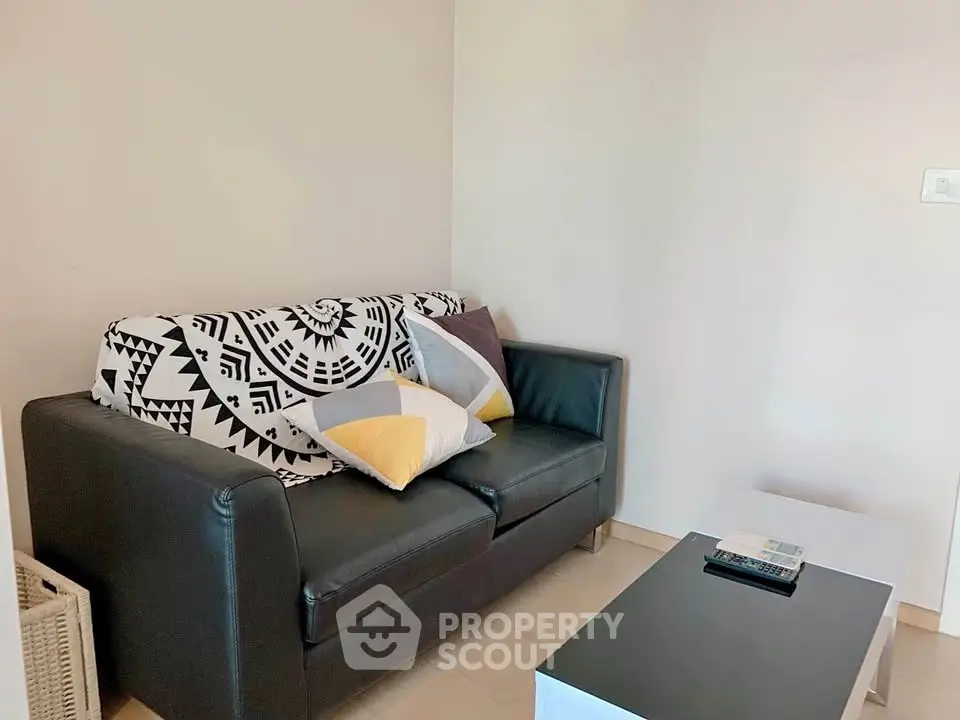 Cozy living room with stylish black sofa and modern coffee table