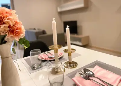 Elegant dining setup in modern living room with stylish decor and soft lighting.