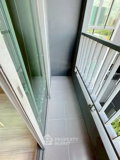 Modern apartment balcony with sleek railing and city view