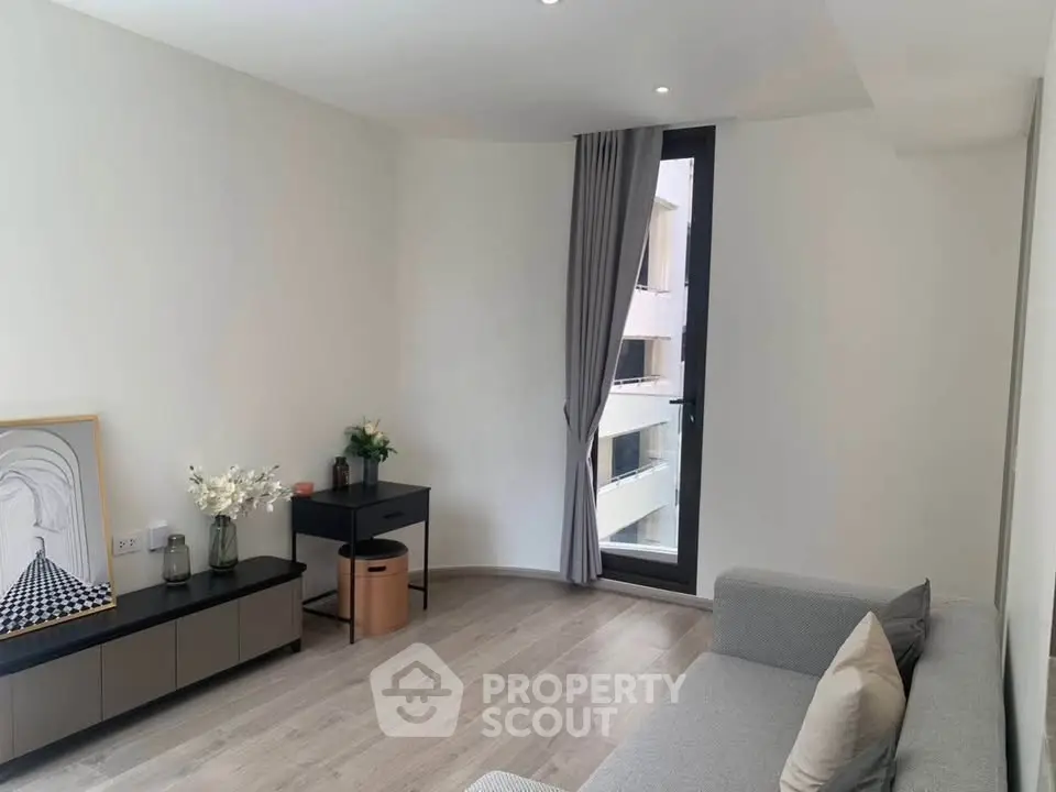 Modern living room with sleek furniture and large window for natural light