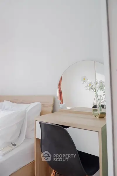 Chic bedroom with modern vanity and mirror, perfect for stylish living.