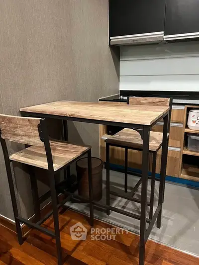 Modern kitchen with sleek cabinetry and stylish high-top dining set