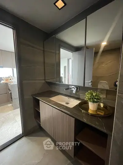 Modern bathroom with sleek design and elegant fixtures, featuring a stylish vanity and large mirror.