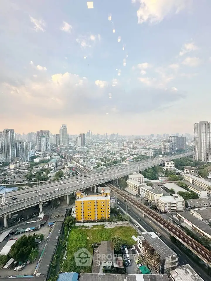 Stunning cityscape view from high-rise building showcasing urban skyline and infrastructure.