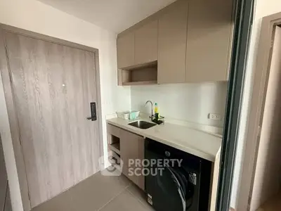Modern kitchen with sleek cabinetry and built-in washing machine