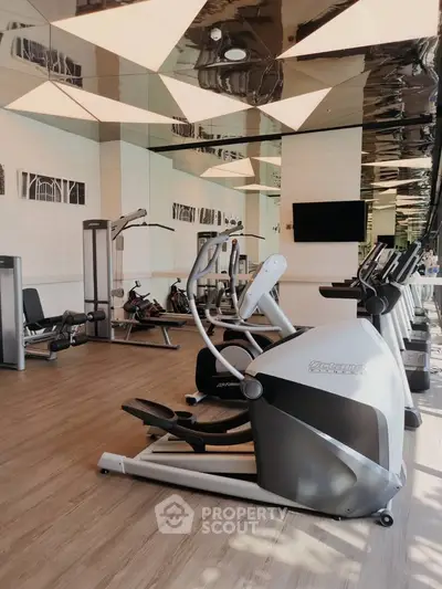 Modern gym with state-of-the-art fitness equipment and stylish interior design.