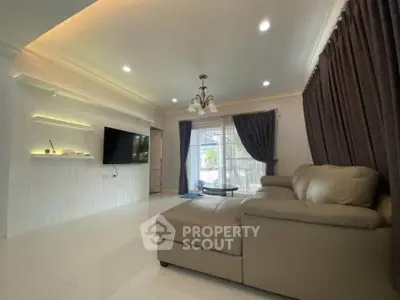 Spacious living room with modern decor and large windows for natural light.