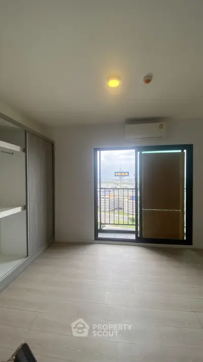 Spacious bedroom with balcony and built-in wardrobe in modern apartment