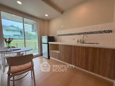 Charming kitchen with open layout and scenic view, featuring modern appliances and cozy dining area.