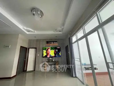 Spacious living room with modern decor and large windows